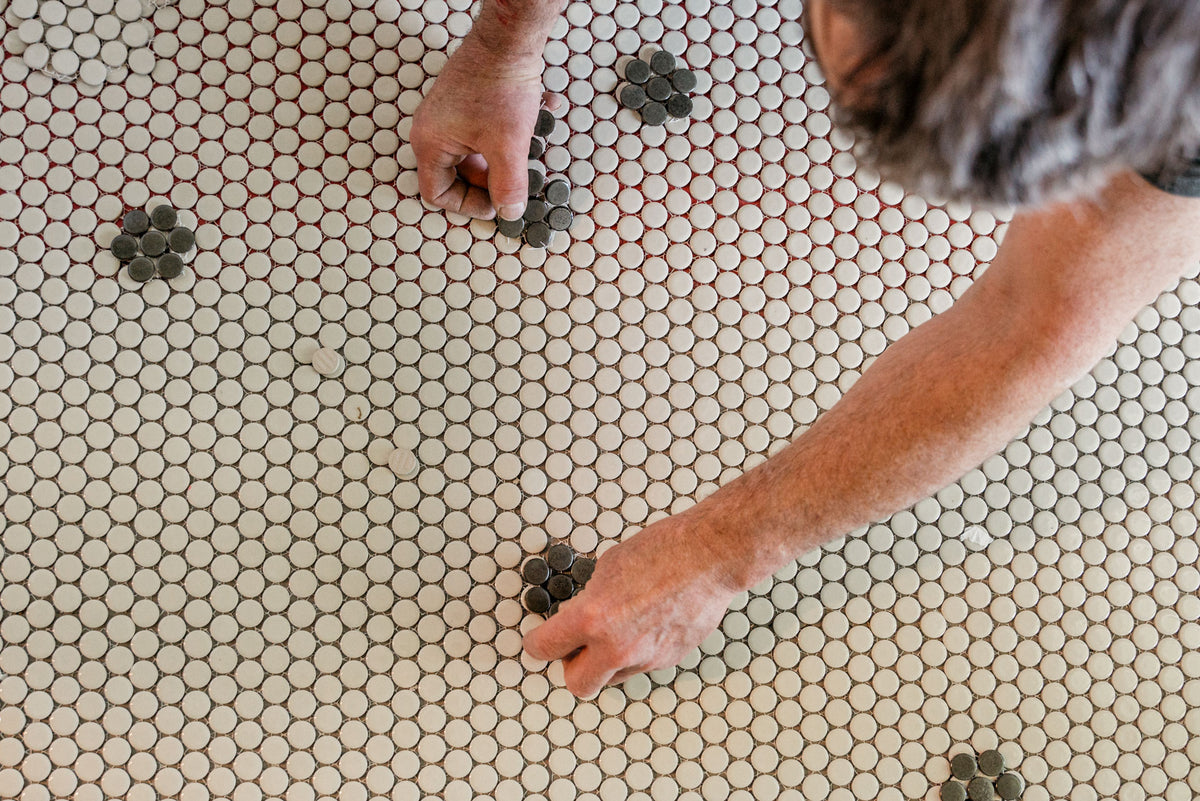 Precision tile installation for an Elliott Cole Home commercial interior design project, showcasing careful alignment, craftsmanship, and attention to detail.